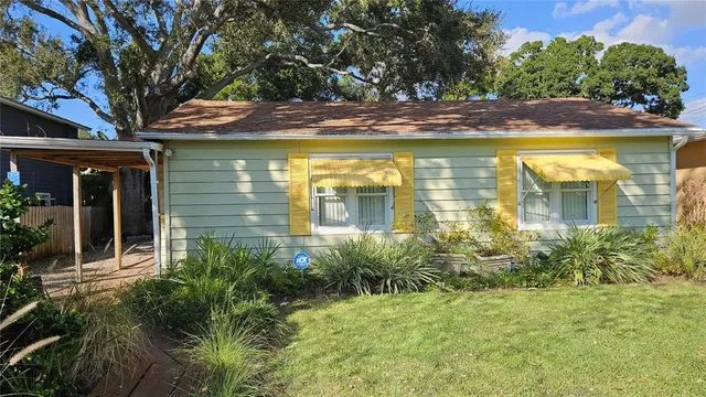 a view of a house with pool and trees in the background