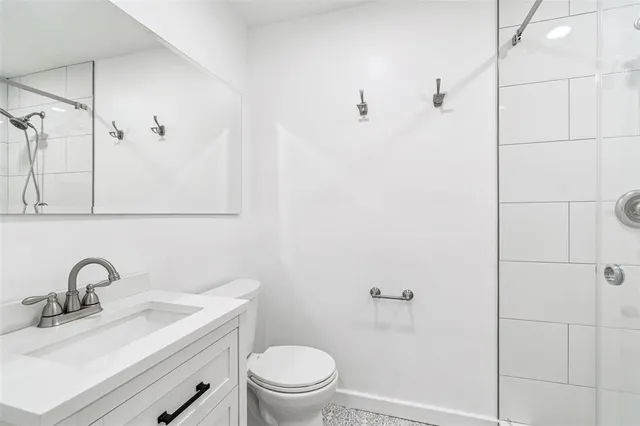 a view of an empty room with window and chandelier fan