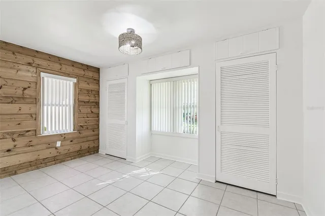 a view of a house with a yard and wooden fence and large tree