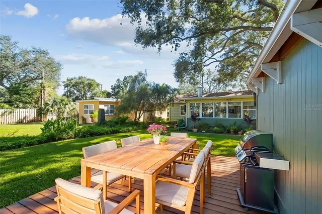 a view of a wooden deck with large trees