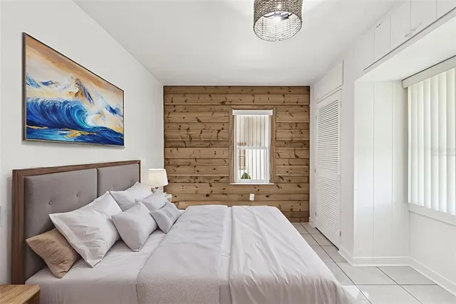 a bedroom with a bed and a painting on the wall