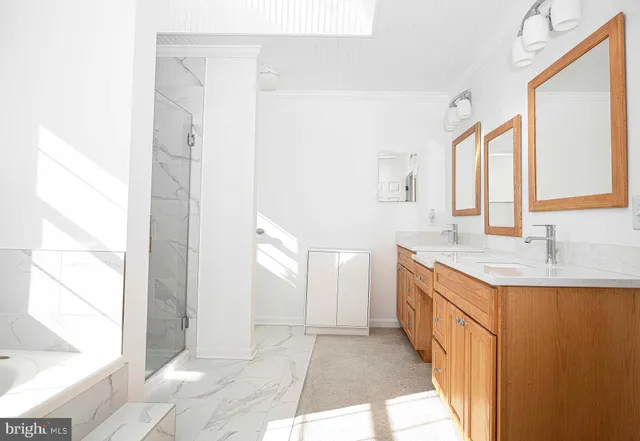 a bathroom with a granite countertop sink a mirror and a bathtub
