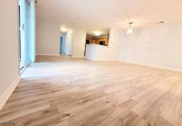 a view of a kitchen with a sink and a large window