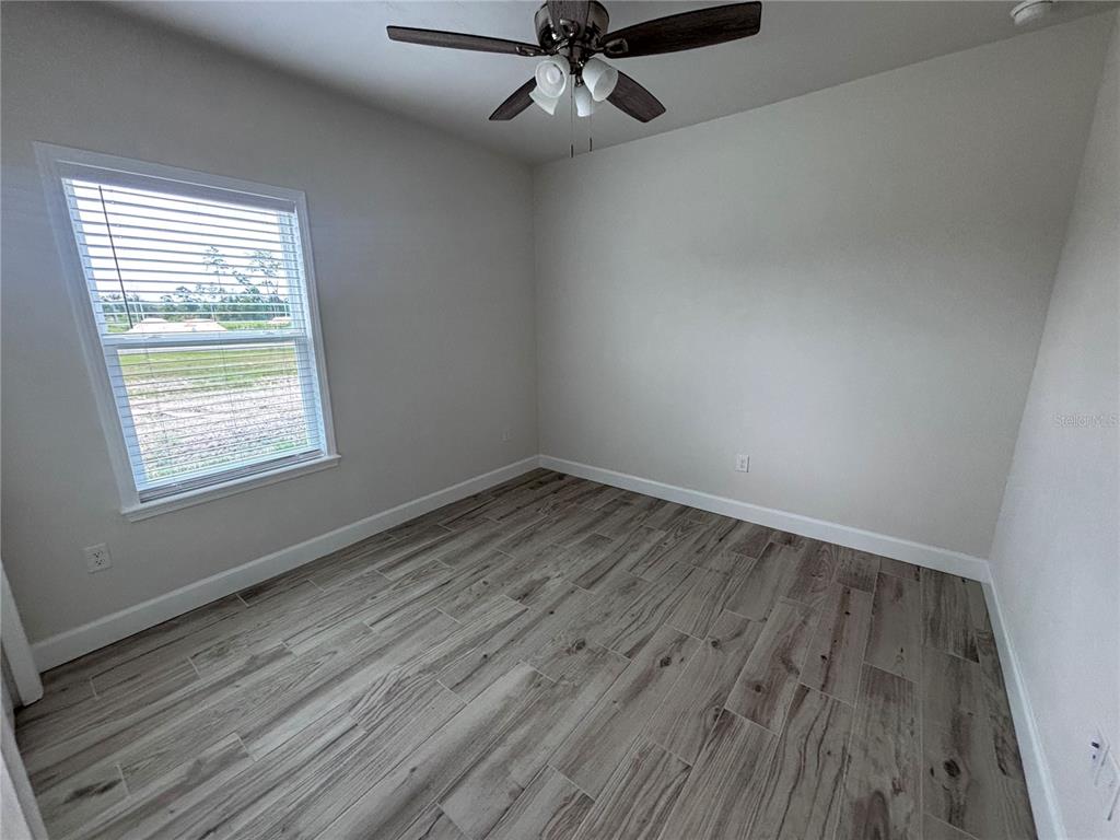 6686 Southwest 11th Lane Gainesville, FL 32607 - Photo 14 of 24 wooden floor in an empty room with a window