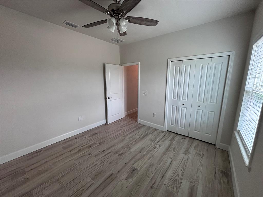 6686 Southwest 11th Lane Gainesville, FL 32607 - Photo 15 of 24 a view of an empty room with wooden floor and a window