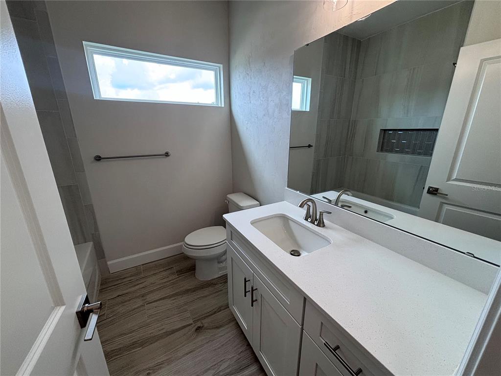 6686 Southwest 11th Lane Gainesville, FL 32607 - Photo 16 of 24 a spacious bathroom with a double vanity sink toilet and a mirror