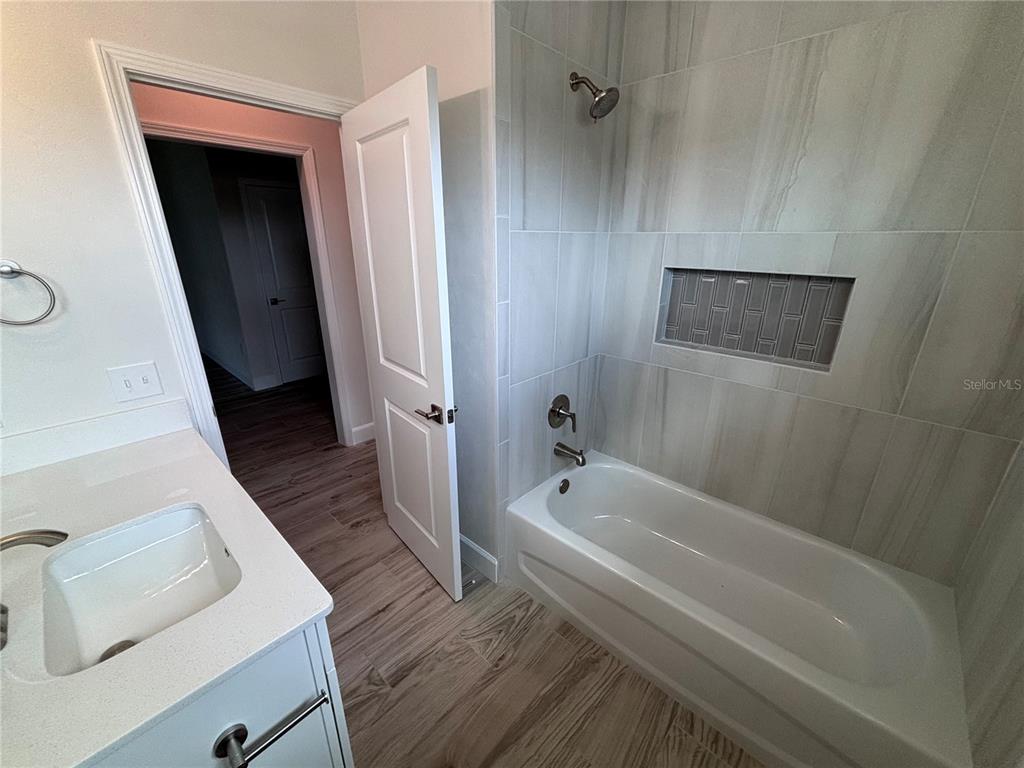 6686 Southwest 11th Lane Gainesville, FL 32607 - Photo 17 of 24 a bathroom with a sink a toilet and shower