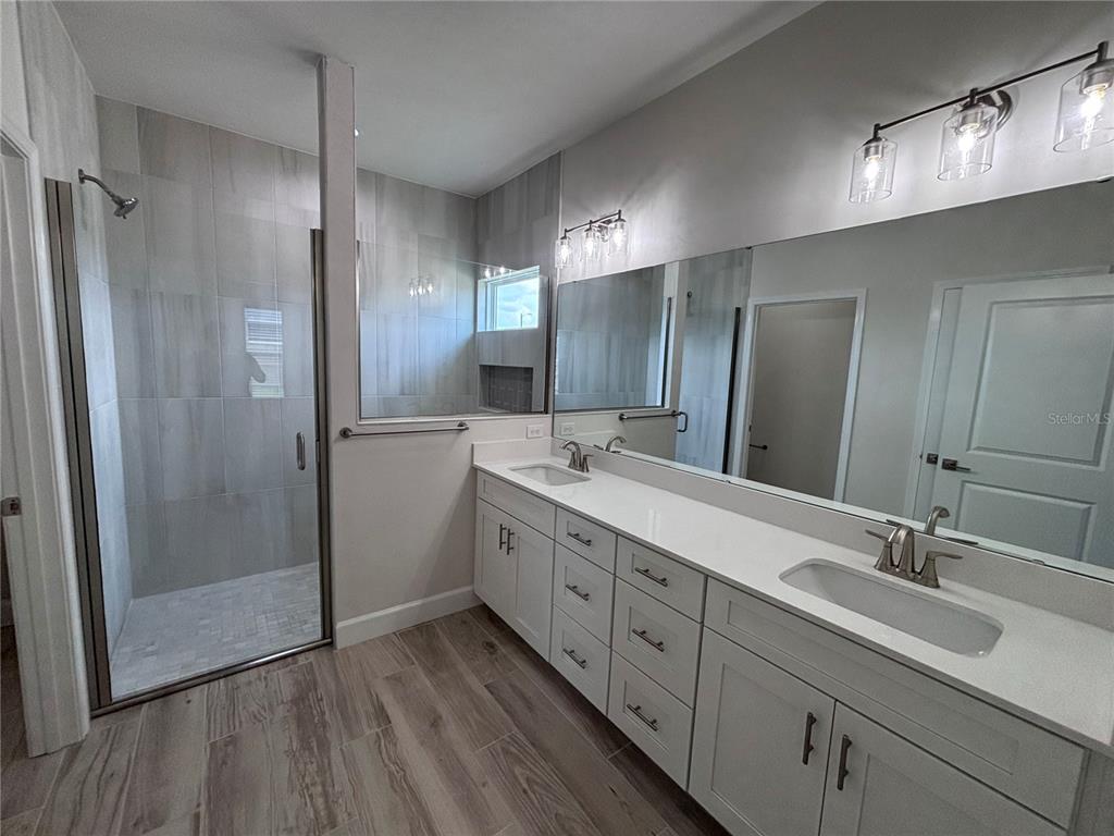 6686 Southwest 11th Lane Gainesville, FL 32607 - Photo 2 of 24 a bathroom with double vanity sink and shower