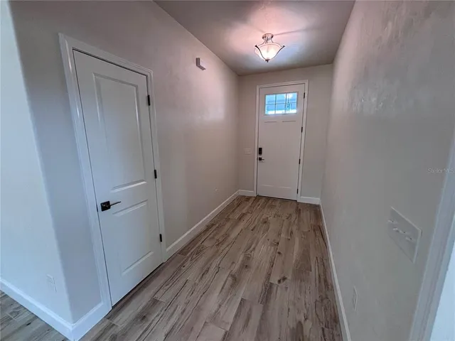a view of a hallway with wooden floor