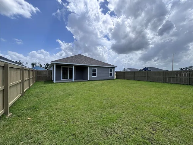 a backyard of a house with lots of green space