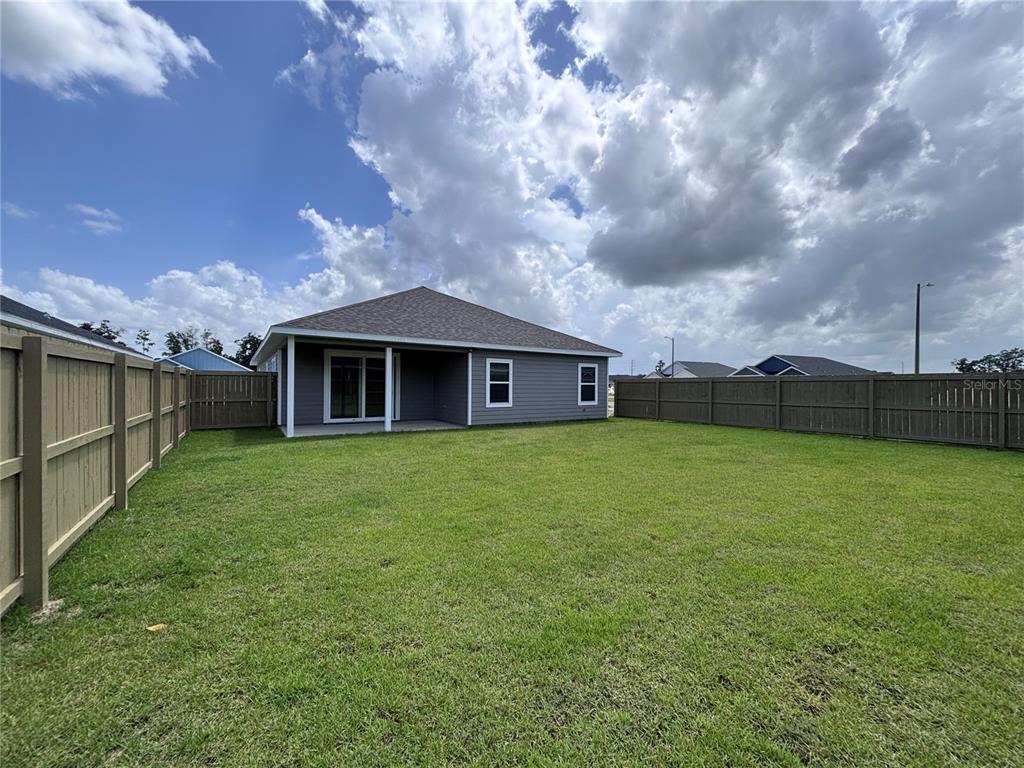 6686 Southwest 11th Lane Gainesville, FL 32607 - Photo 23 of 24 a backyard of a house with lots of green space