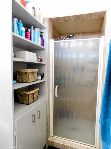a kitchen with a refrigerator and a shelf