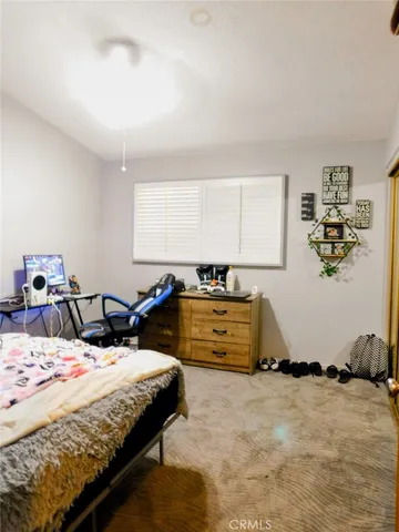 a bedroom with double bed and a cabinets