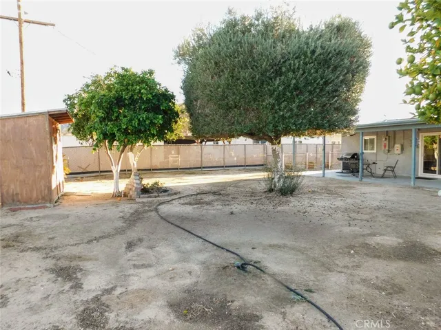a backyard of a house with plants and trees
