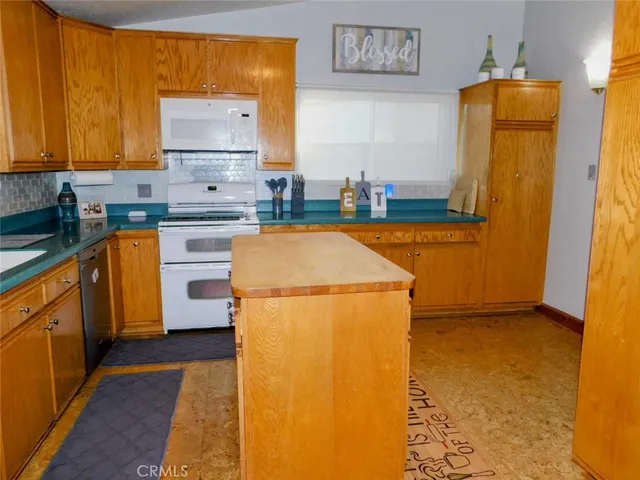 a kitchen with sink a refrigerator and a stove