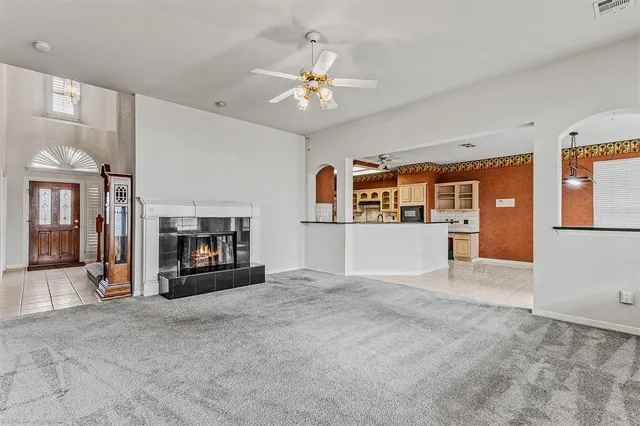 a view of a livingroom with an empty space and a fireplace