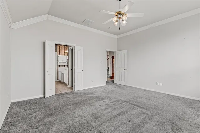 a view of an empty room with a ceiling fan