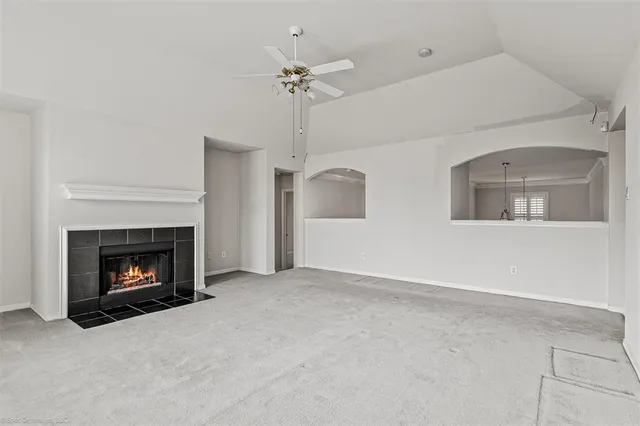 a view of an empty room and a ceiling fan