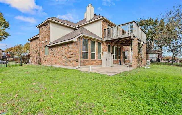 a house with green field in front of it