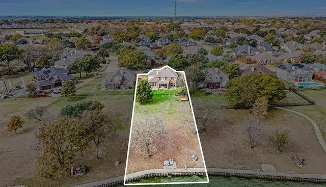 an aerial view of a houses with yard