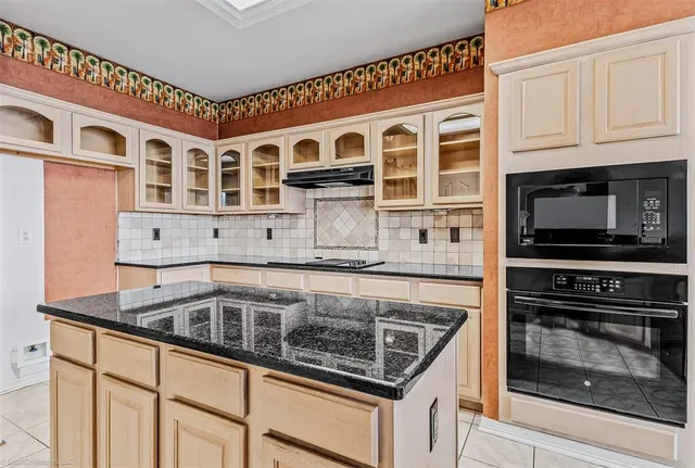 a kitchen with stainless steel appliances granite countertop a stove and a microwave