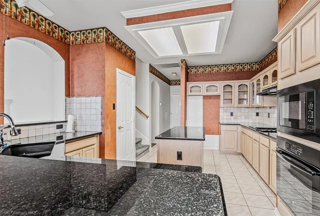 a kitchen with stainless steel appliances granite countertop a stove and a sink