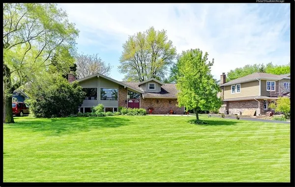 a house view with a sitting space and garden