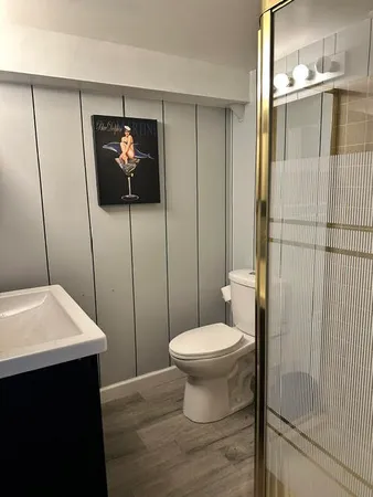 a bathroom with a sink toilet and shower