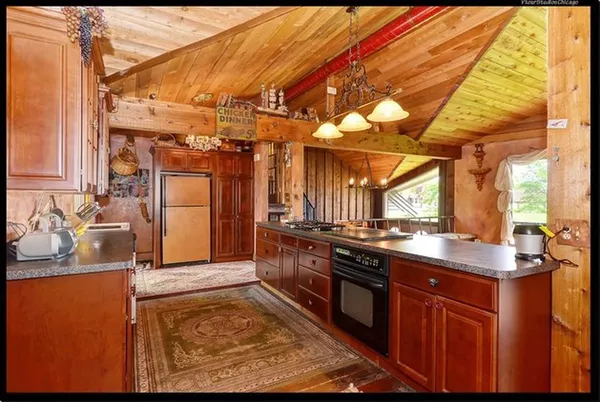 a kitchen with stainless steel appliances granite countertop a sink and cabinets