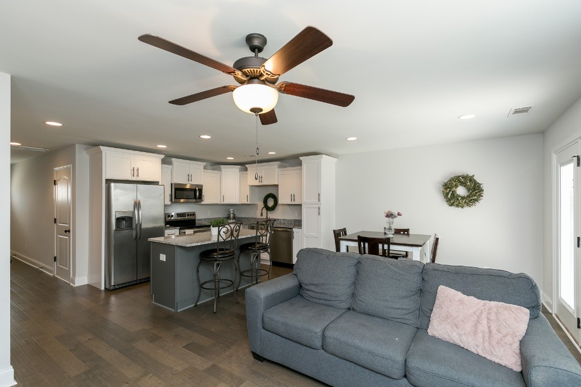 272 Signature Place Lebanon, TN 37087 - Photo 15 of 36 a living room with stainless steel appliances kitchen island furniture and a chandelier