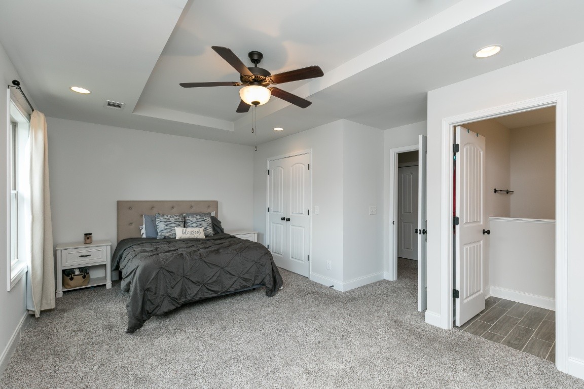 272 Signature Place Lebanon, TN 37087 - Photo 22 of 36 a bedroom with a bed and a chandelier