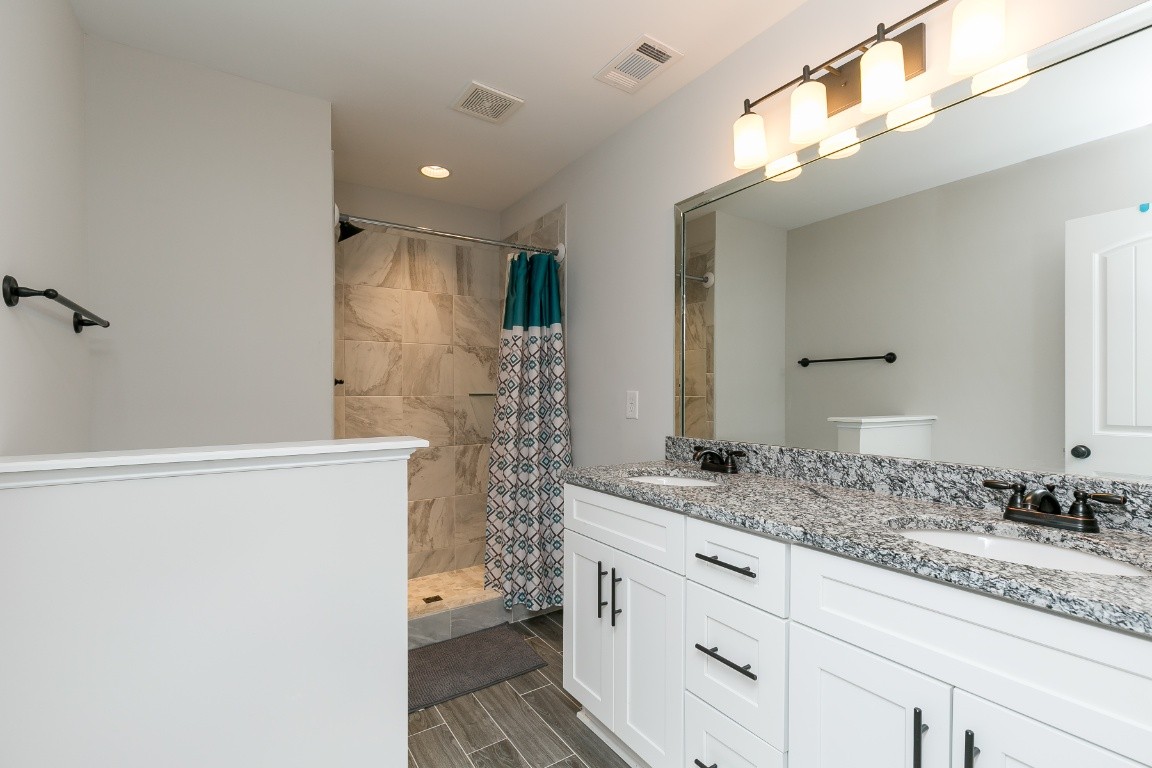 272 Signature Place Lebanon, TN 37087 - Photo 24 of 36 a bathroom with a granite countertop sink and a mirror