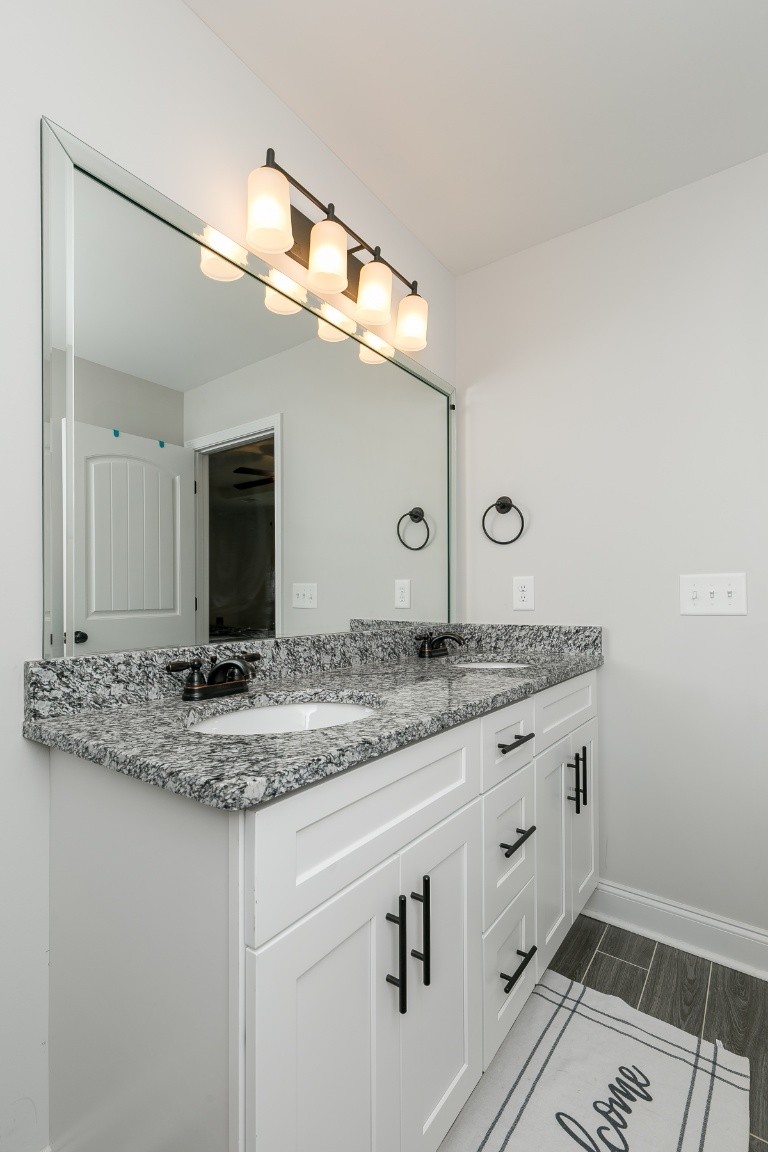 272 Signature Place Lebanon, TN 37087 - Photo 25 of 36 a bathroom with a granite countertop sink and a mirror