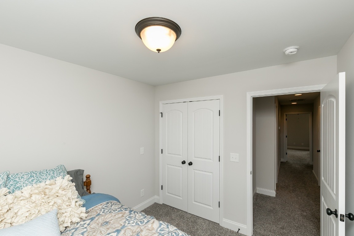 272 Signature Place Lebanon, TN 37087 - Photo 30 of 36 a bedroom with a bed and a mirror