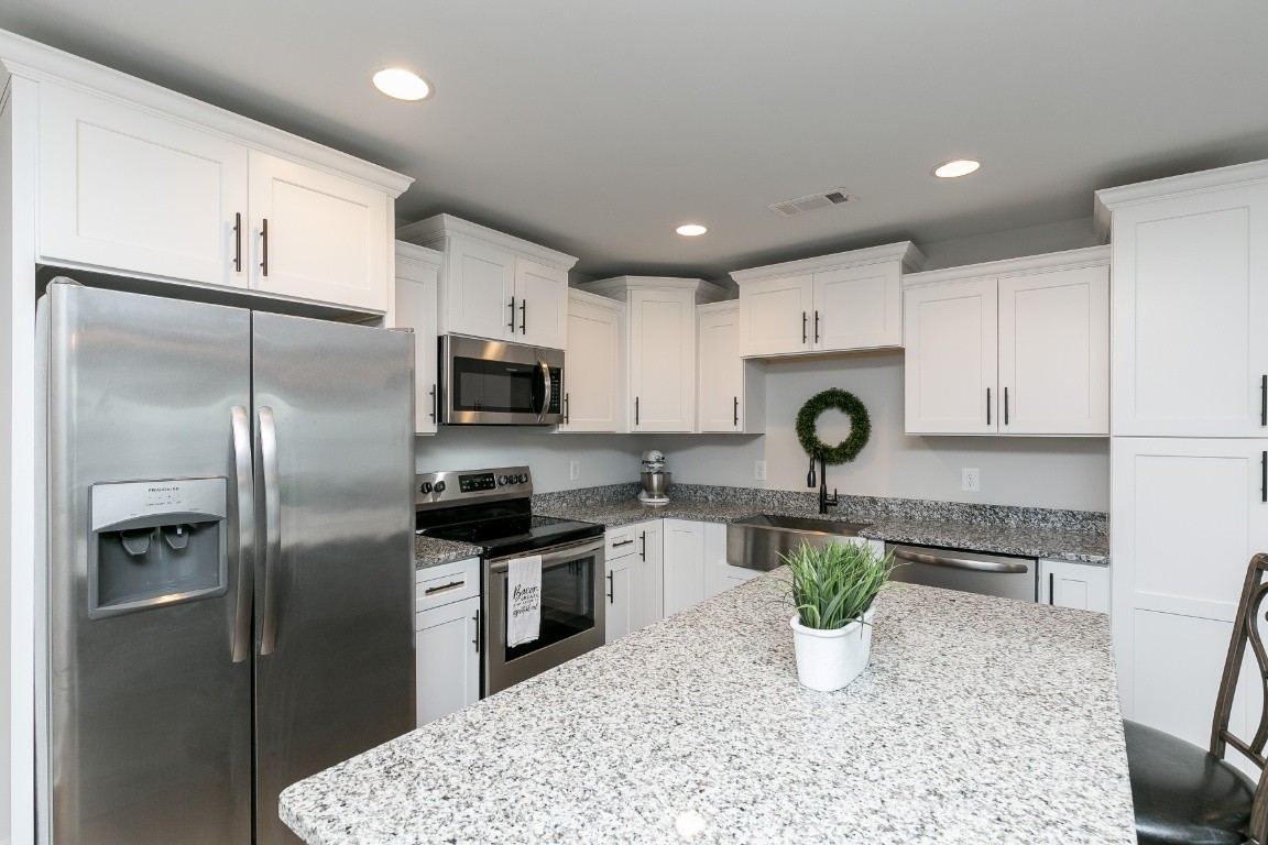 272 Signature Place Lebanon, TN 37087 - Photo 10 of 36 a kitchen with a refrigerator a stove a microwave and cabinets