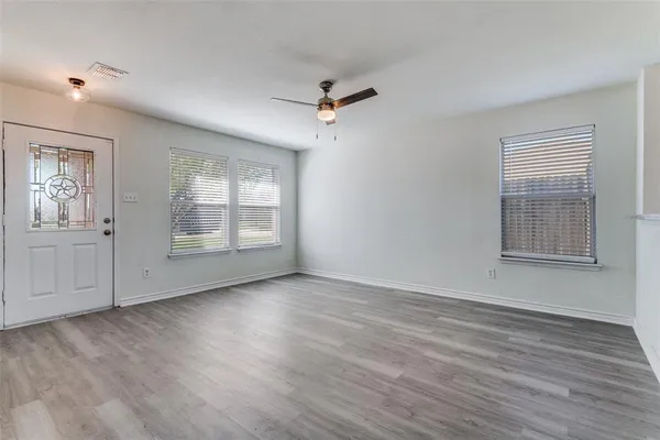 wooden floor in an empty room with a window