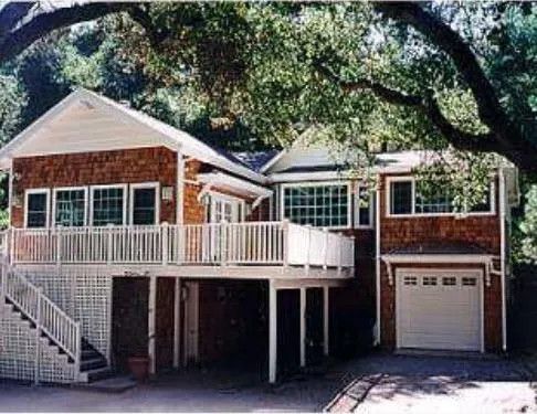 a roof deck with table and chairs