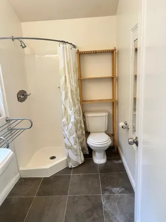 a bathroom with a toilet and a shower