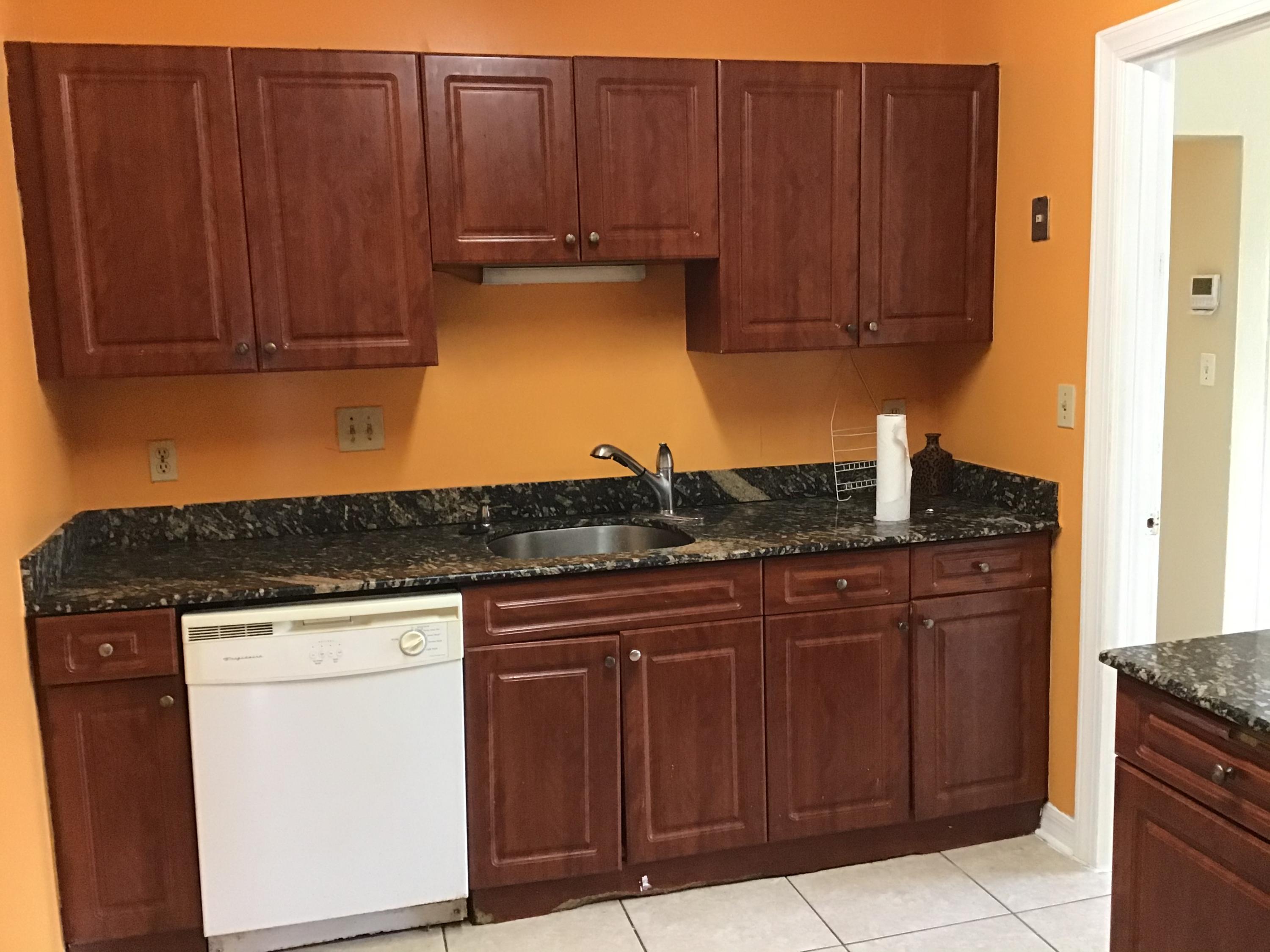 1116 Colonial Road Fort Pierce, FL 34950 - Photo 11 of 19 a kitchen with granite countertop wooden cabinets and a stove top oven