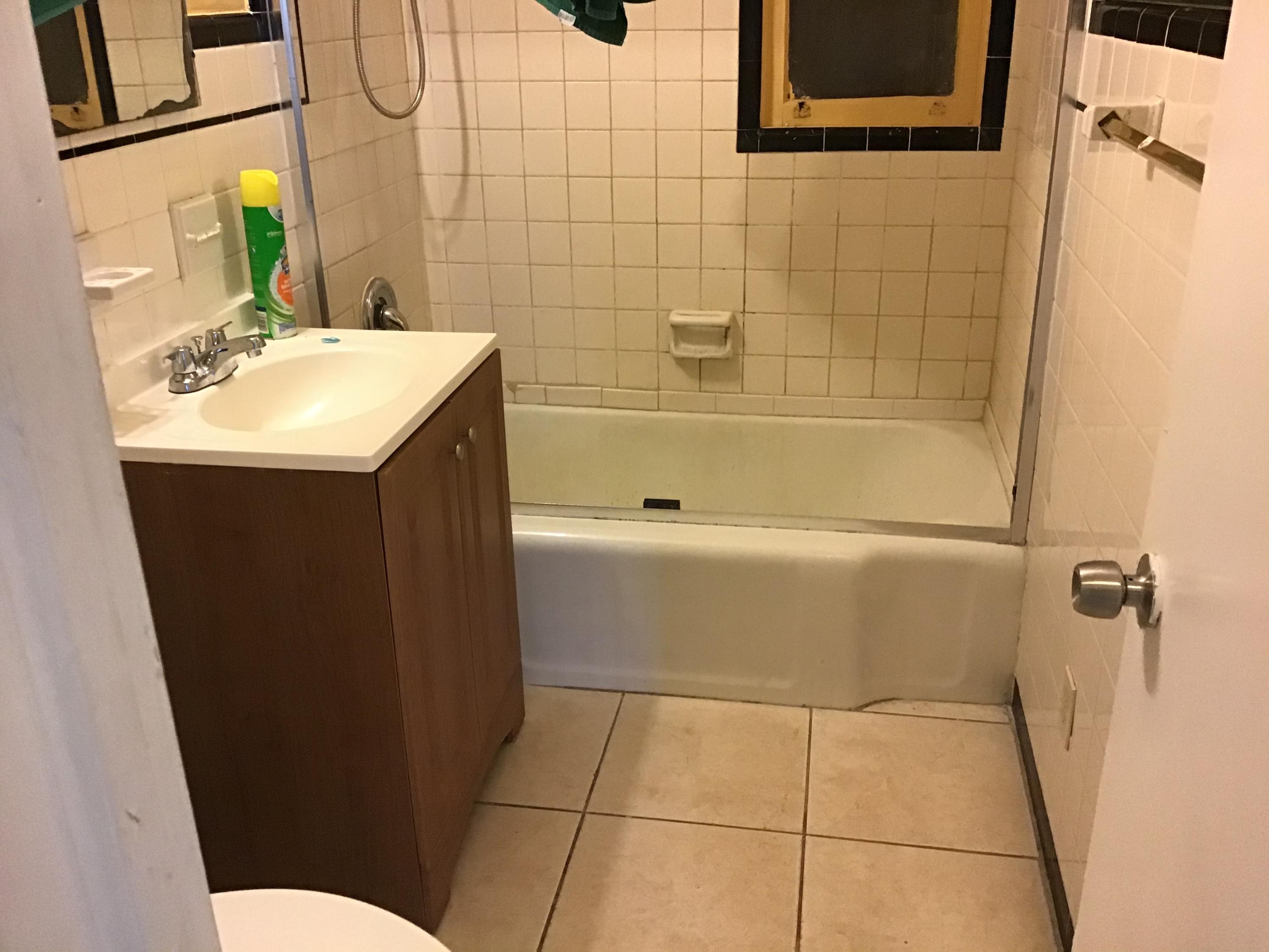 1116 Colonial Road Fort Pierce, FL 34950 - Photo 13 of 19 a bathroom with a sink a toilet and shower