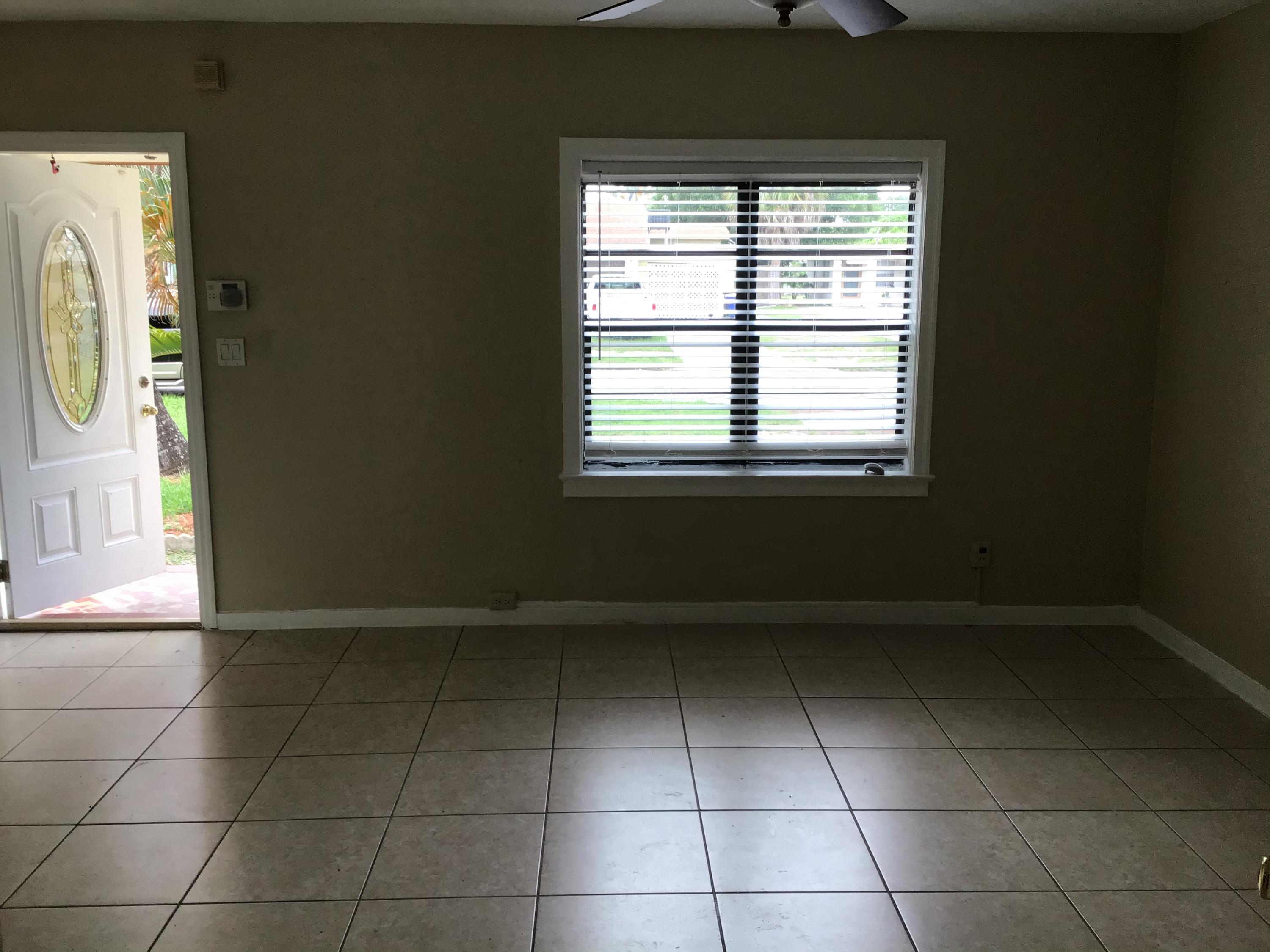 1116 Colonial Road Fort Pierce, FL 34950 - Photo 15 of 19 a view of an empty room with a window
