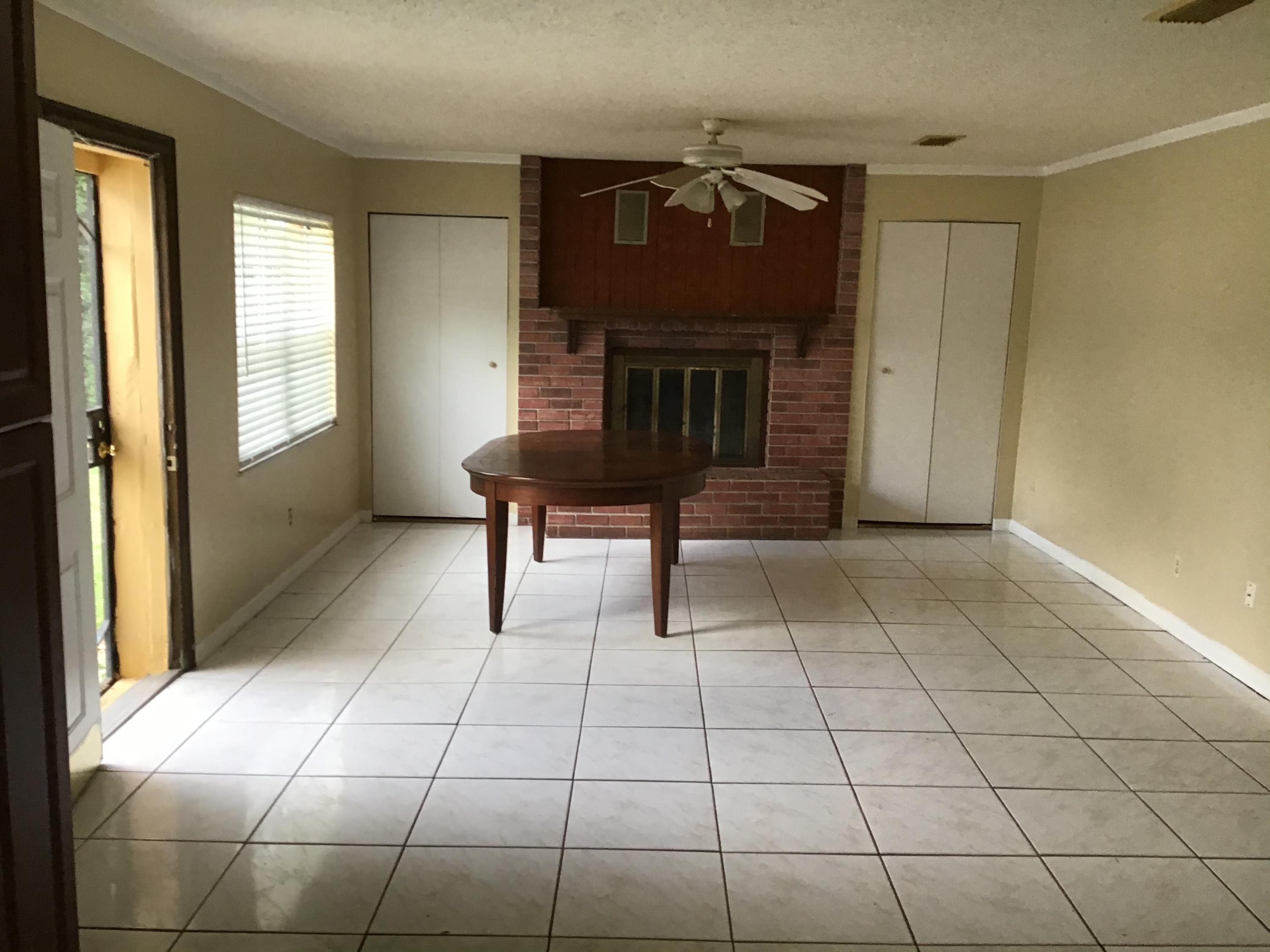 1116 Colonial Road Fort Pierce, FL 34950 - Photo 5 of 19 a view of a livingroom with furniture and a fireplace