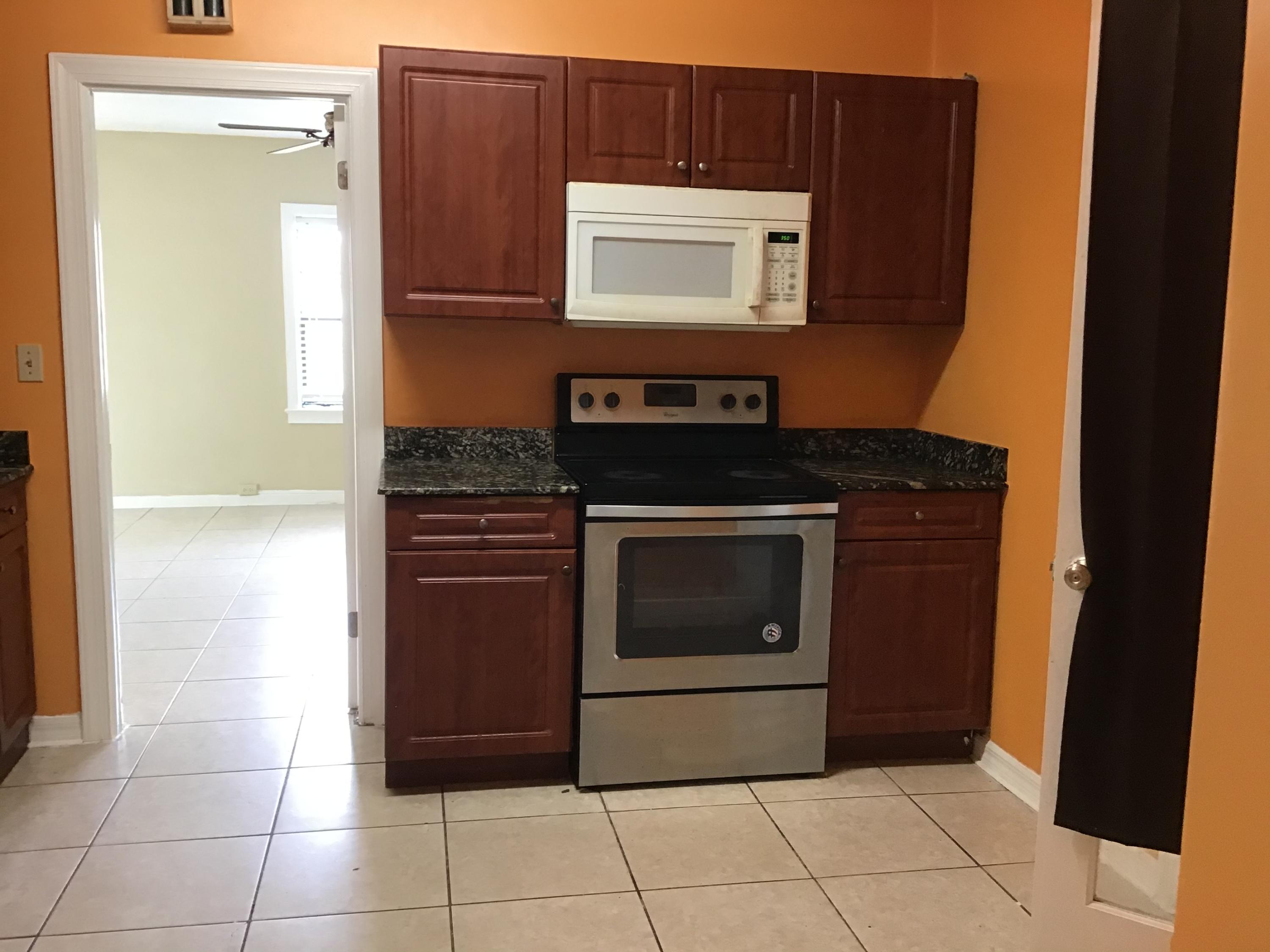 1116 Colonial Road Fort Pierce, FL 34950 - Photo 10 of 19 a kitchen with a stove and a microwave