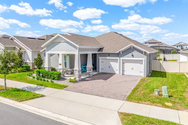 a living room with furniture kitchen view and a wooden floor