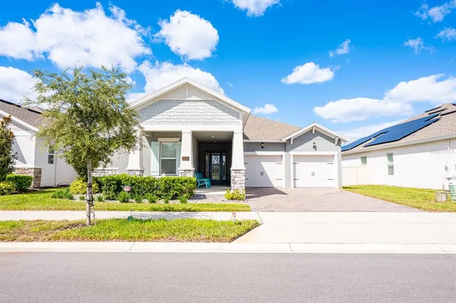 a kitchen with stainless steel appliances granite countertop a refrigerator a stove top oven a sink dishwasher and white cabinets with wooden floor