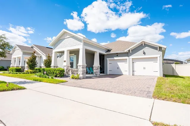 a kitchen with a sink dishwasher a stove and white cabinets with wooden floor