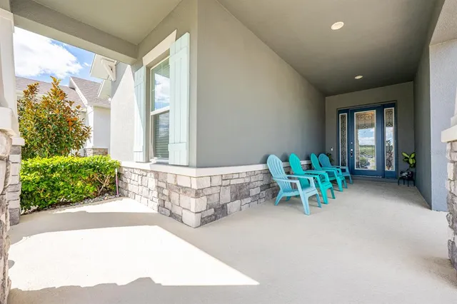 a kitchen with stainless steel appliances granite countertop a stove a sink a microwave a dining table and chairs with wooden floor