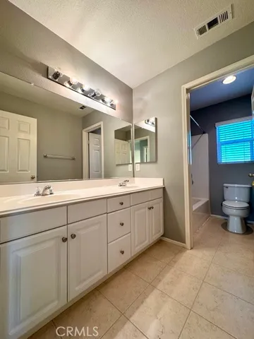 an empty room with a ceiling fan and window