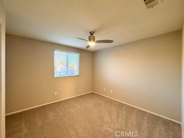 a view of a livingroom with a chandelier fan