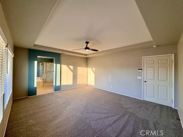 a spacious bathroom with a mirror a shower and vanity